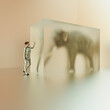 © Don Smith/Stocksy - Woman with elephant in frosted glass cube