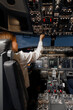 © Danil Nevsky/Stocksy - Female aviator controlling modern aircraft