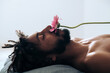 © Lucas Ottone/Stocksy - Man with a flower