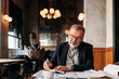 © Studio Firma/Stocksy - Businessman Working in Cafe