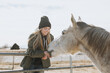 © Leah Flores/Stocksy - Rancher Feeding A Horse Carrots