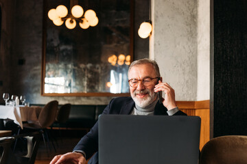 Senior Man Working in Cafe