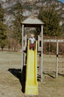 © Anna Malgina/Stocksy - A funny little toddler on a slide