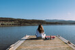 © David Prado/Stocksy - Unrecognizable woman doing yoga on wooden pier