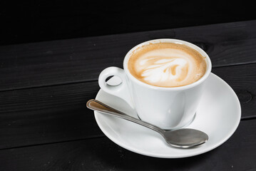 cup of cappuccino on the black background