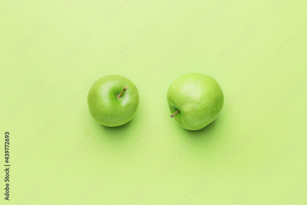 Fresh green apples on color background