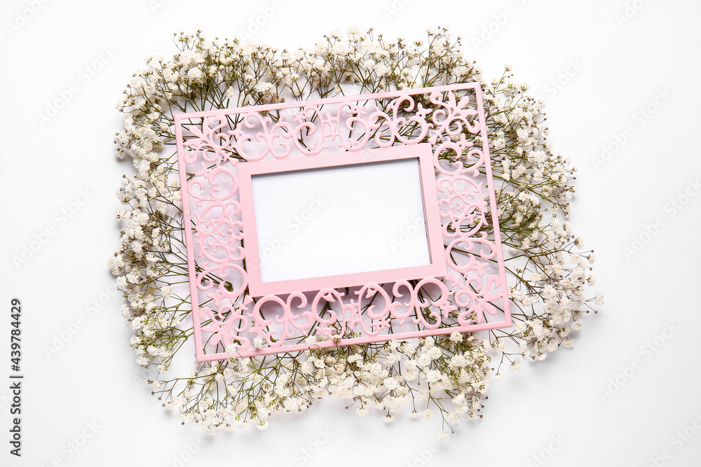 Blank frame and beautiful gypsophila flowers on white background