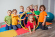 © oksix - Portrait of smiling children with hula hoops