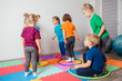 © oksix - Sport activities with hula hoops at kindergarten