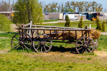 Old Wooden Cart With Hay At Farmyard