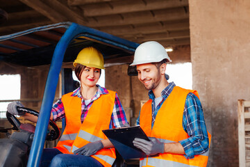 Young professional factory workers discussing working issues