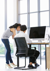 Asian business people sitting on chair in modern office and using computer, white screen and blank mock up of any content will filled