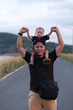 © Attakorn - parent and son.Asian boy sits on his father's shoulder.