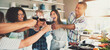 © Flamingo Images - Group of friends cheering at kitchen.