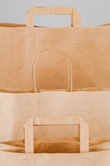 Wall Mural - Brown paper bag with handles, empty shopping bag with area for your logo or design, food delivery concept.