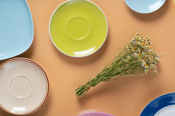 Wall Mural - a bouquet of dried daisies and empty plates.