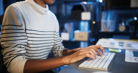 Asian business woman type keyboard, work late night using desktop computer in home office. Hard working business people, work from home or internet information technology concept
