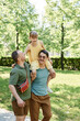 © AnnaStills - Adopted little girl walking with her family outdoors in the park