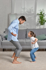 father and his cute little daughter train at home.