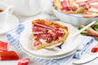 A slice of rhubarb pie or tart  on a white plate. Summer healthy dessert. Selective focus