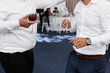 © Sandu - Two men at a party with glasses of wine in hands, friends celebrating at an event.