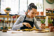 © Inuk Studio/Stocksy - Craftswoman working with antique carved object