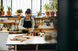 © Inuk Studio/Stocksy - Positive female artisan restoring wooden piece