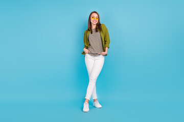 Wall Mural - Full body photo of charming young woman hold hands pockets wear sunglass isolated on blue color background