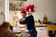 © Léa Jones/Stocksy - kids preparing holiday treats in the kitchen