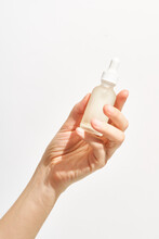 Bottle With Skincare Product In Hand Of Woman