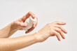 © Martí Sans/Stocksy - Woman applying hand care cream