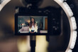 © Léa Jones/Stocksy - view of camera recording a video of a woman who is vlogging.