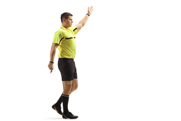 Wall Mural - Full length shot of a football referee showing a sign with hand