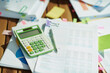 Closeup on desk with documents for taxes, calculator and pen