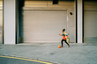 © Javier Díez/Stocksy - Confident female footballer with ball in city
