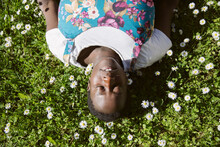 Black Woman Lying On Meadow