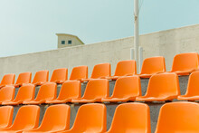 The Orange Color Bleachers Are Empty Inside The Stadium