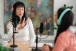 © Studio Marmellata/Stocksy - Cheerful Asian women preparing for podcast recording