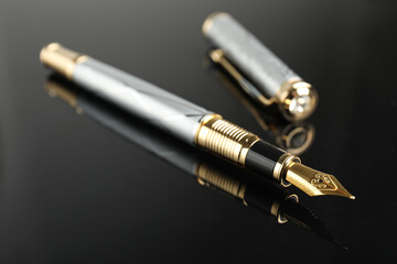 Beautiful fountain pen with ornate nib on black background, closeup