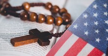 American Flag Against Cross Rosary Over Bible