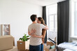 © Hernandez & Sorokina/Stocksy - Couple Hugging In Their New Home