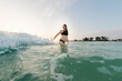 © Alison Winterroth/Stocksy - A pregnant mom in bikini waits for a wave