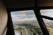 © Marcos Osorio/Stocksy - View of rainbow from inside a helicopter through the window