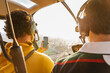 © Marcos Osorio/Stocksy - Helicopter passenger taking photos with his mobile