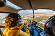 © Marcos Osorio/Stocksy - Helicopter passenger taking photos with his mobile