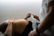© Santi Nuñez/Stocksy - Anonymous pregnant woman Ultrasound Obstetrician. Ecography