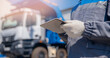 Concept banner automated logistics online internet. Dump truck driver man in uniform with tablet computer controls loading of cargo or coal