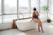 © Irina Polonina/Stocksy - Beautiful curvy young woman takes a bath.