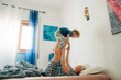 © Olga Moreira/Stocksy - Mother and her son playing in bed