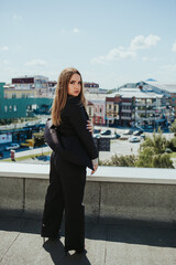 Canvas Print - Young attractive Caucasian girl posing on the background of a cityscape